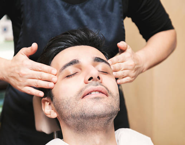 Young Turkish man getting skin care and facial massage - male beauty